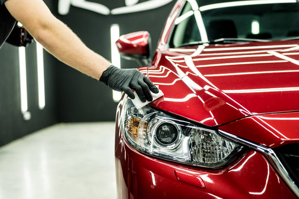 Car service worker applying nano coating on a car detail. - Foto, Bild