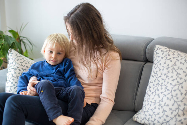 Mother, tickling her little toddler boy, child giggling at home with mom in living room - Fotoğraf, Görsel