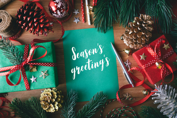 Season's greeting's concepts with cards and gift box present,ornament element on wood table background.Merry christmas and winter collection images - Foto, Imagem