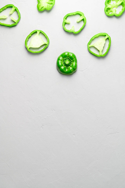 Eco food concept. Top view of sliced green peppers on gray background. Minimal style. - Foto, immagini