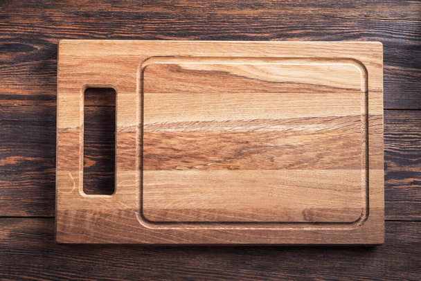 Lege houten snijplank op een tafel. Bovenaanzicht. kopieer ruimte voor tekst - Foto, afbeelding