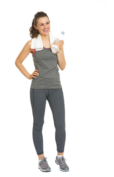 Full length portrait of smiling fitness young woman with bottle  - Fotó, kép