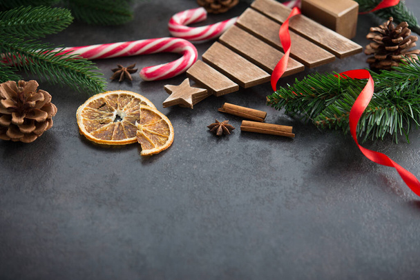 Concepto de Feliz Navidad con abeto, conos y bastones de caramelo sobre un fondo de piedra. - Foto, imagen