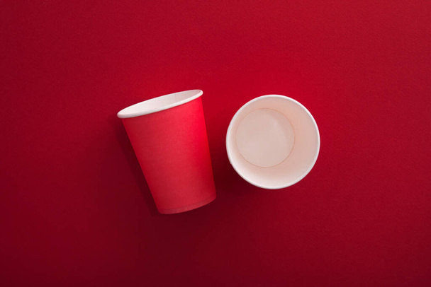 Red paper cup of coffee on a pastel background. Creative pop art. Waste concept. Minimal space. - Foto, afbeelding