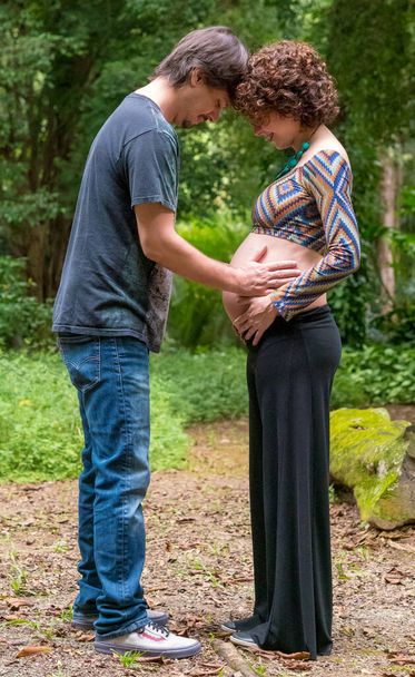 Brazilian affectionate pregnant couple touching stomach  - Fotó, kép