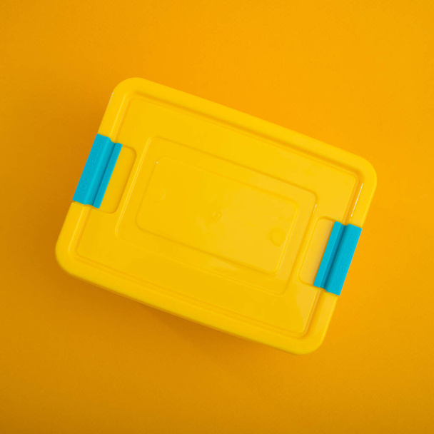 Plastic container box on a yellow background. School lunch box. - Fotografie, Obrázek