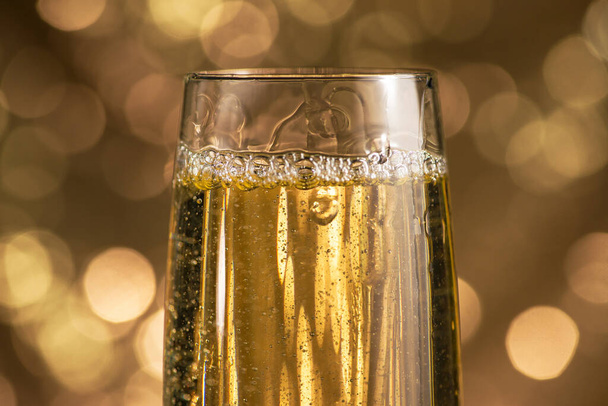 Closeup of champagne glass on a bokeh light background. Happy celebration of New Year. - Foto, imagen