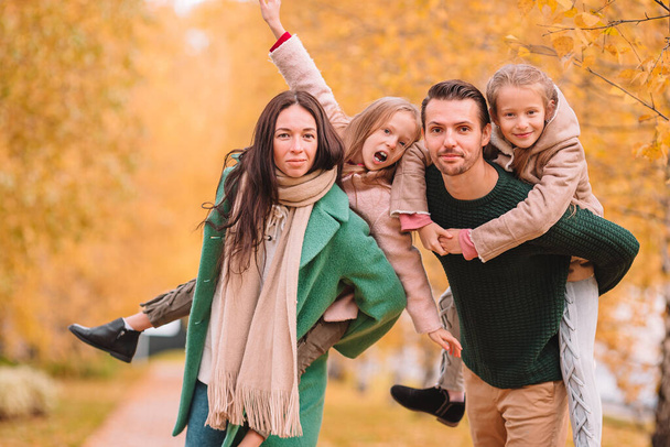 Portrait of happy family of four in autumn - Φωτογραφία, εικόνα