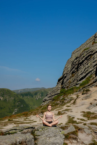 Yoga, Meditation. Woman balanced, practicing meditation and zen energy yoga in mountains. Girl doing fitness exercise sport outdoors in morning. Healthy lifestyle concept - Photo, image