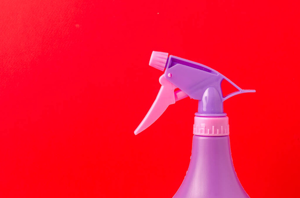 spray nozzle on a bottle/purple spray nozzle on a bottle on a red background. - Zdjęcie, obraz