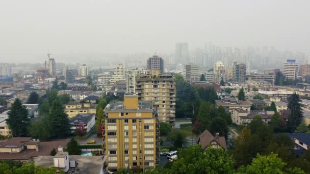 Drone shot of Vancouver buildings with downtown in the smoke on background - Filmagem, Vídeo
