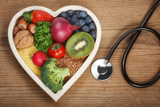 Healthy food in heart shaped bowl. - Foto, afbeelding