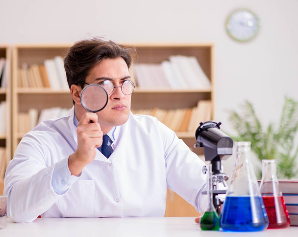 Gekke gekke wetenschapper dokter doet experimenten in een laboratorium - Foto, afbeelding