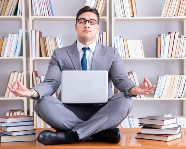 Businessman student in lotus position meditating with a laptop i - Photo, Image