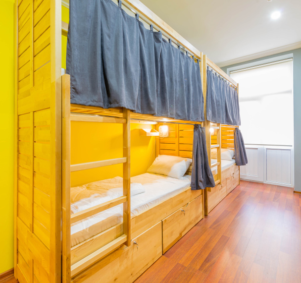 Hostel slaapzaal bedden geregeld in de kamer - Foto, afbeelding