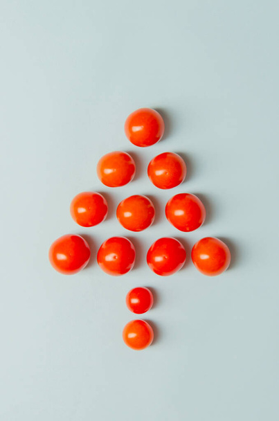 árbol de navidad hecho de tomates en azul - Foto, imagen