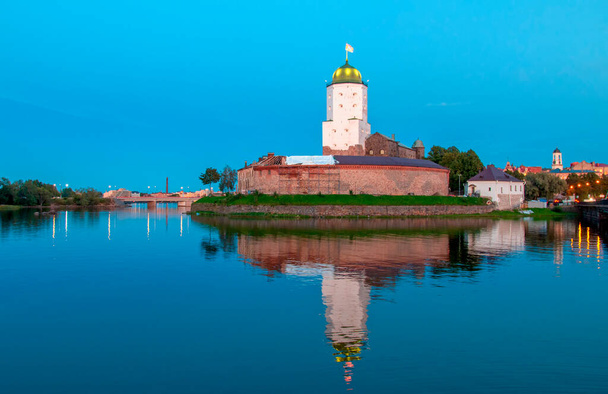 Architecture of old town Vyborg, Russia, Europe. Saint Olaf tower and Vyborg castle on fall sunset. - Photo, Image