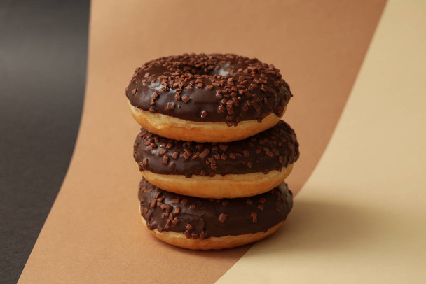Tasty chocolate donuts on three tone background - Photo, Image
