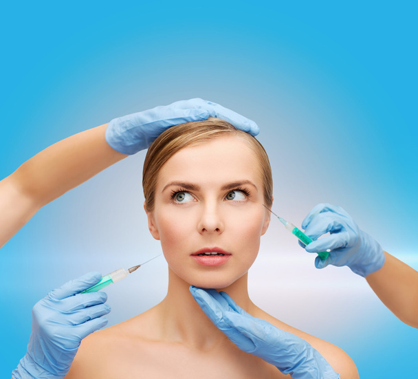 Woman face and beautician hands with syringe - Фото, зображення