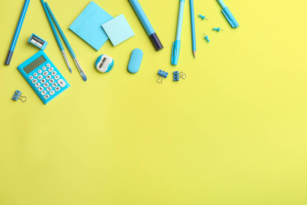 Blue school stationery on yellow background, flat lay with space for text. Back to school - Photo, Image