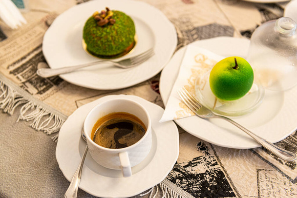 Cup of coffee with delicious dessert. Morning coffee. Selective focus on cup. - Photo, Image