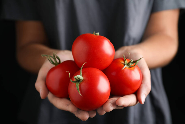Farmer holding fresh ripe tomatoes, closeup view - Photo, Image