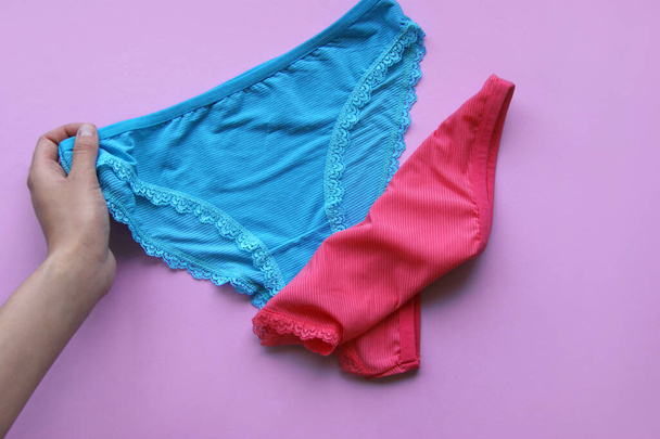 Set of women's panties on a pink background. Pink and blue underwear. - Photo, Image