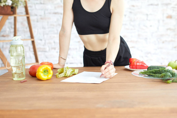 Girl counting calories. Young woman use her diet plan. Healthy lifestyle and balanced eating for weight loss and fitness - Photo, image