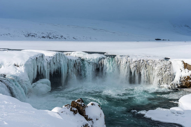 Scenic winter view of Godafoss waterfall in Iceland. Picturesque winter landscape with frozen waterfall in Iceland. - Foto, immagini