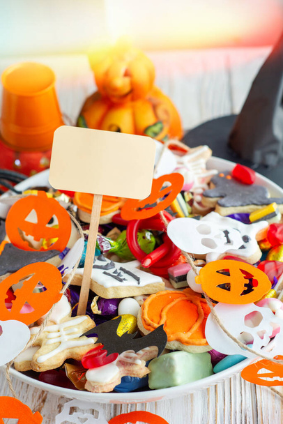 Halloween Jack o Lantern candy bowl with pumpkin sweets, candy and halloween cookies Trick or Treat - Фото, зображення