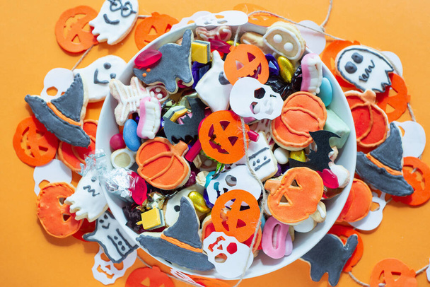Halloween Jack o Lantern candy bowl with pumpkin sweets, candy and halloween cookies Trick or Treat - Photo, image