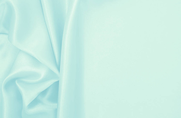 Lisse élégante soie bleue ou satin texture de tissu de luxe peut utiliser comme fond abstrait. Design de fond luxueux - Photo, image
