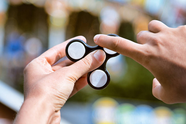 classic new trendy game for all. Hand spinner fidgeting hand toy - Foto, imagen