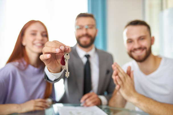 close-up photo of keys, realtor giving key from apartment to owners - Photo, image