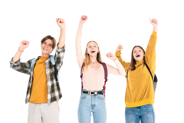 Excited teenagers with backpacks showing yes gesture and looking at camera isolated on white - Photo, Image