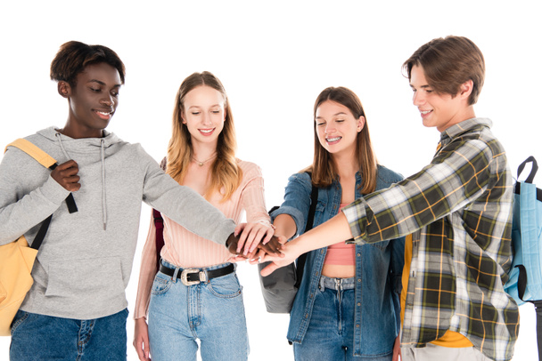 Cheerful multiethnic teenagers holding hands isolated on white - Valokuva, kuva
