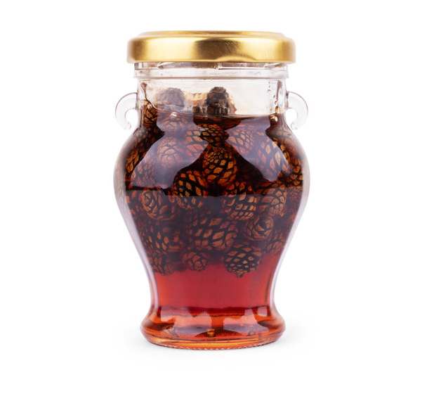 Glass jar of pine cone jam isolated on white - Zdjęcie, obraz