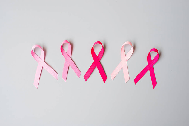 October Breast Cancer Awareness month, Pink Ribbon on grey background for supporting people living and illness. International Women, Mother and World cancer day concept - Photo, Image