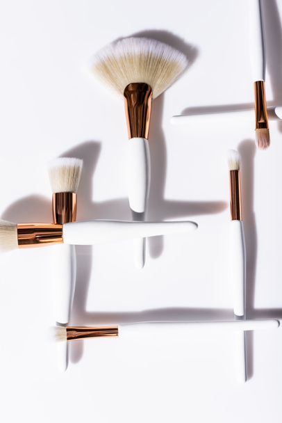 flat lay with cosmetic brushes set on white background - Фото, зображення