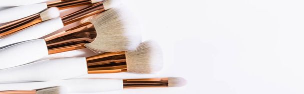 top view of cosmetic brushes set on white background with copy space, panoramic shot - Фото, зображення