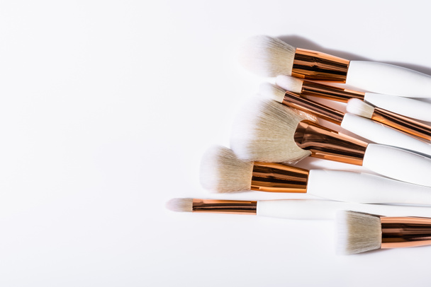 top view of cosmetic brushes set on white background with copy space - Photo, Image