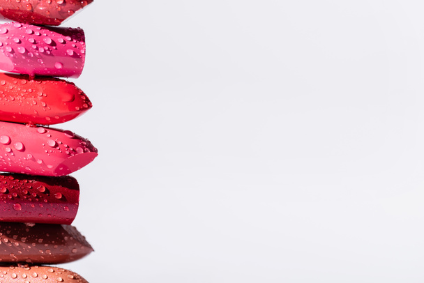 close up view of wet lipsticks in row isolated on white - Valokuva, kuva