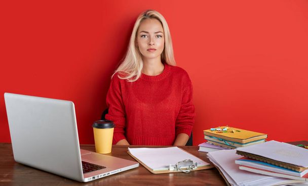 portrait of young caucasian blonde female at work place - 写真・画像