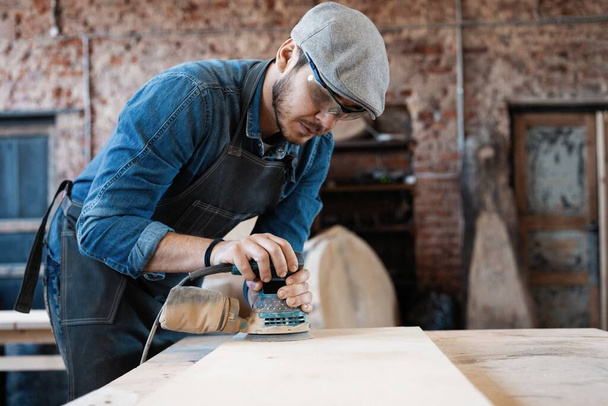 Successful handsome businessman with stylish cap work in carpentry - Zdjęcie, obraz