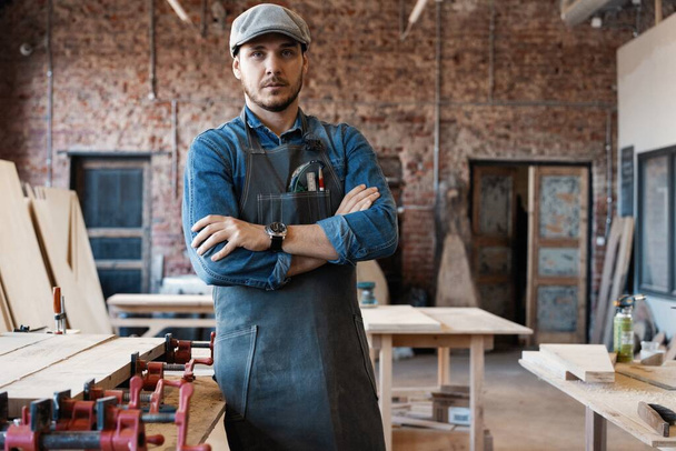 Successful handsome businessman with stylish cap work in carpentry - Фото, зображення