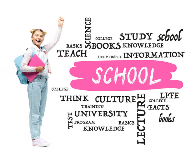 Schoolgirl with laptop and backpack showing yeah gesture near school lettering and illustration on white  - Photo, Image
