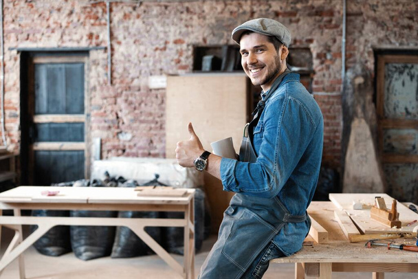 Successful handsome businessman with stylish cap work in carpentry - Foto, afbeelding