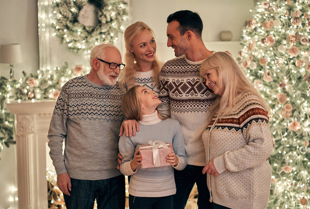 The happy family standing on the christmas tree background - Photo, Image