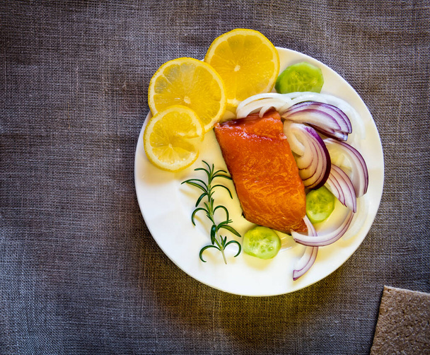 fish fillet with lemon and herbs on a plate - Zdjęcie, obraz