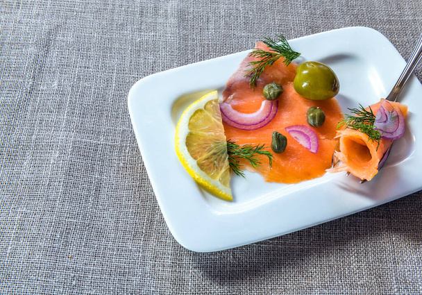 Salmon fillet with lemon and dill on a plate - Fotoğraf, Görsel